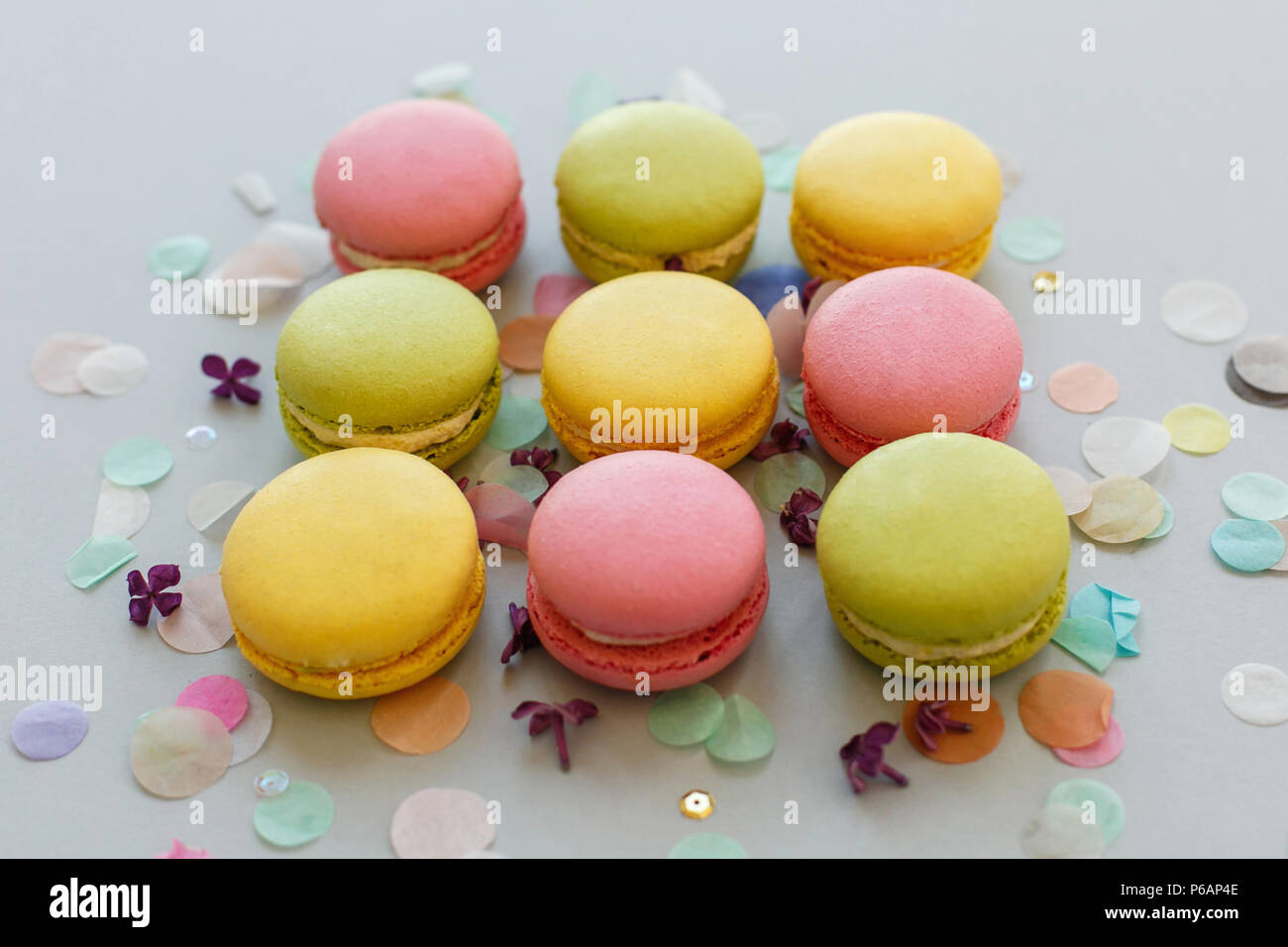 Colorful Macarons On Trendy Pastel Gray Paper With Lilac Flowers And Confetti Tasty Pink Yellow Green And Brown Macaroons Candy Bar For Party Foo Stock Photo Alamy
