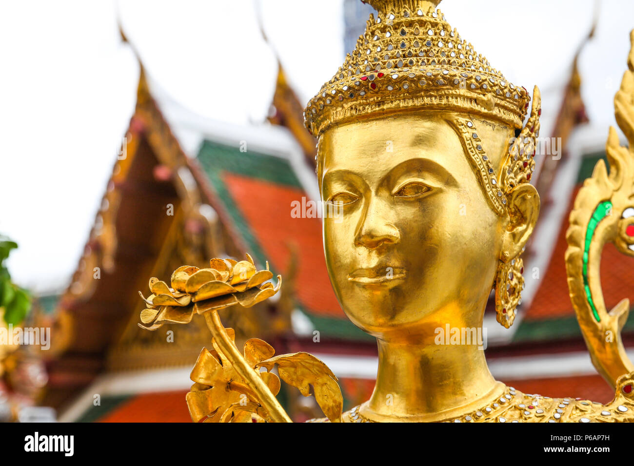 Golden Kinnari statue  at Wat Phra Kaew ,The Temple of Emerald Buddha in Bangkok, Thailand Stock Photo