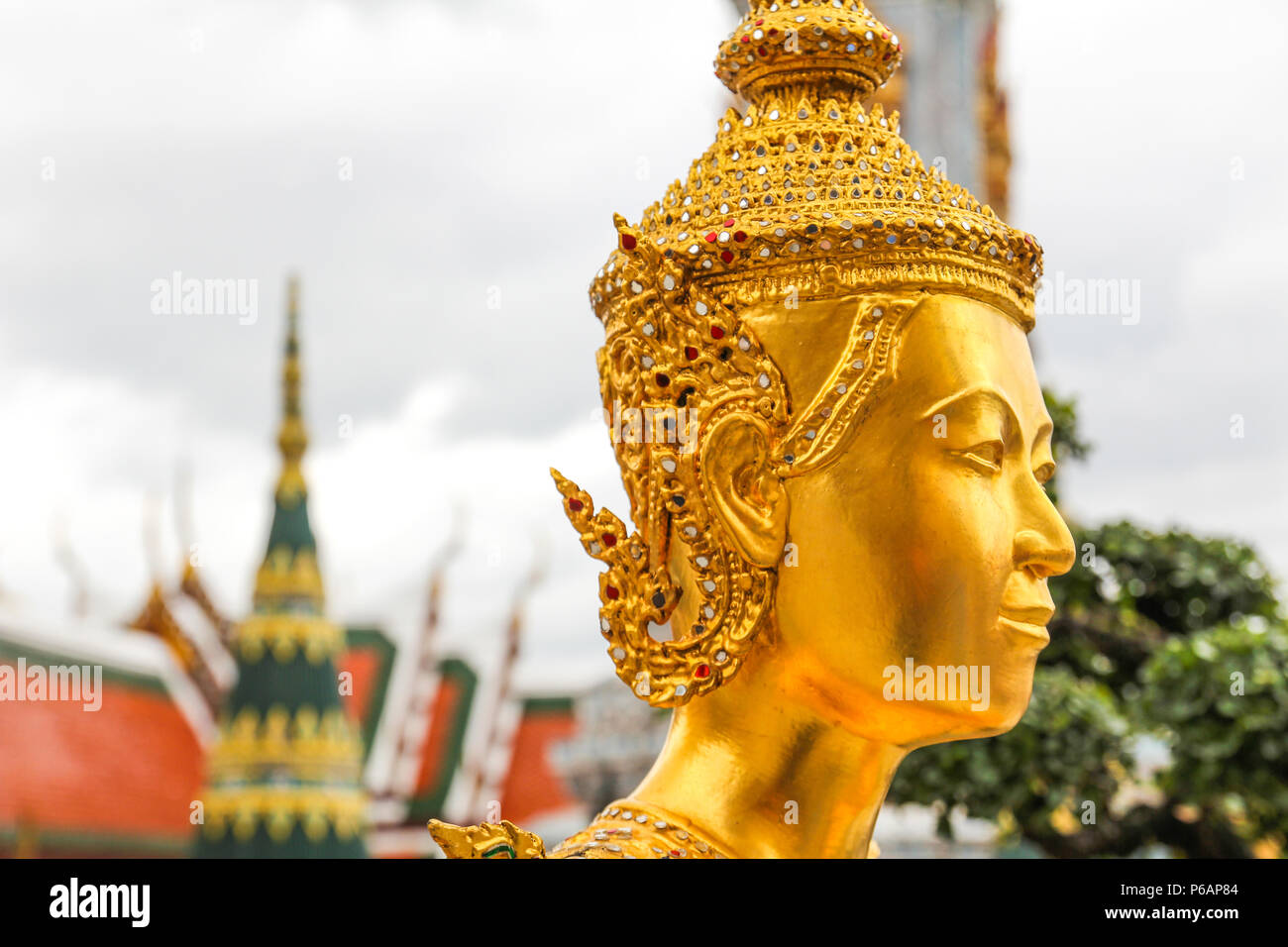 Golden Kinnari statue  at Wat Phra Kaew ,The Temple of Emerald Buddha in Bangkok, Thailand Stock Photo