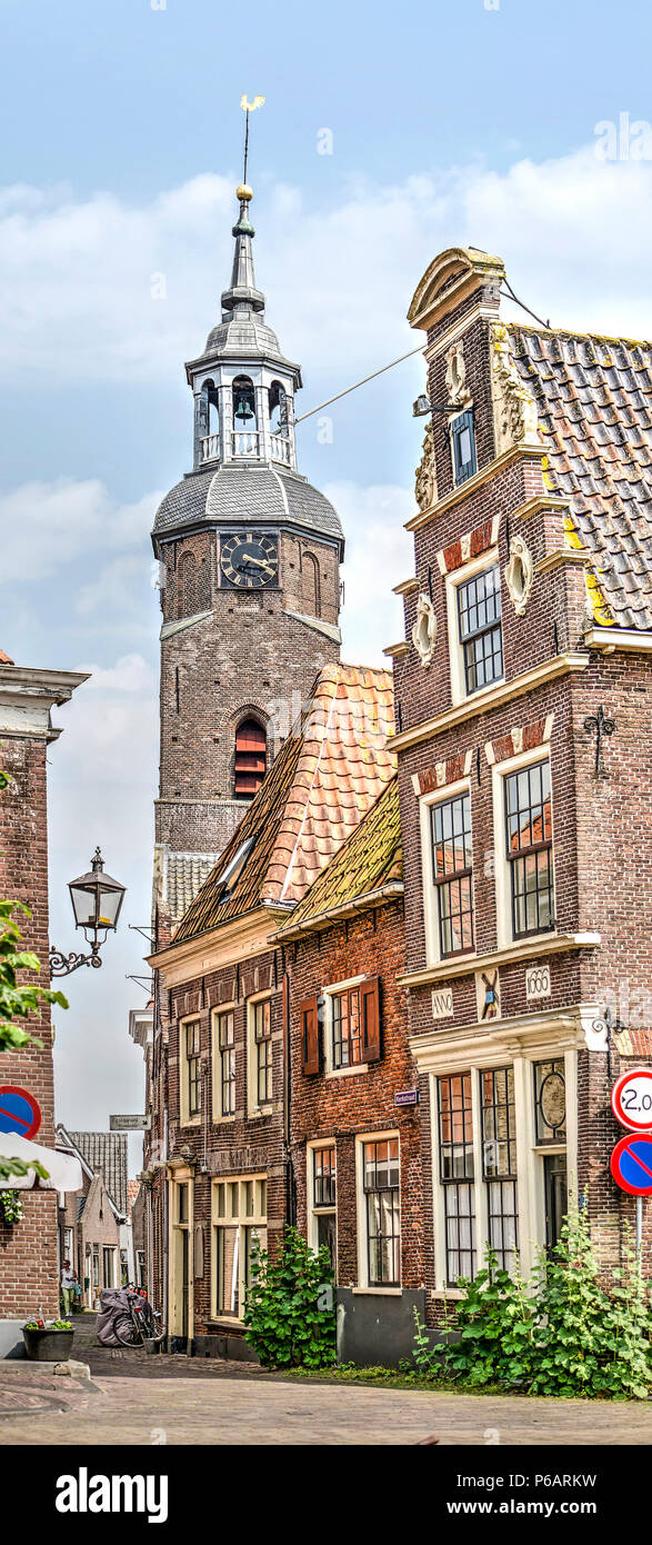 Blokzijl, The Netherlands, June 9, 2018: View of the curving Kerkstraat in the old town, including the tower of the Hervormde Church Stock Photo