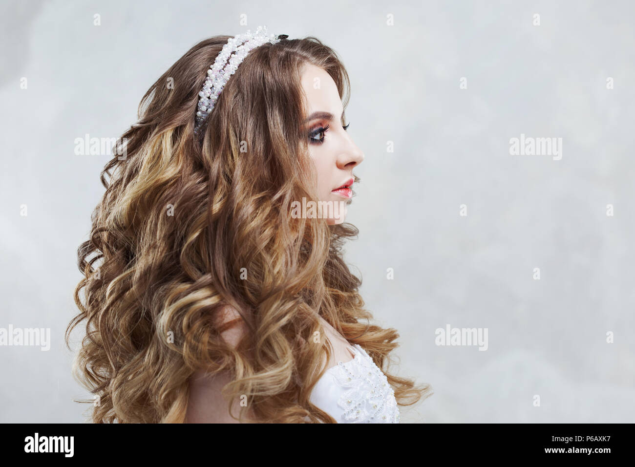 Young Charming Bride In Wedding Dress Make Up And Hairstyle With
