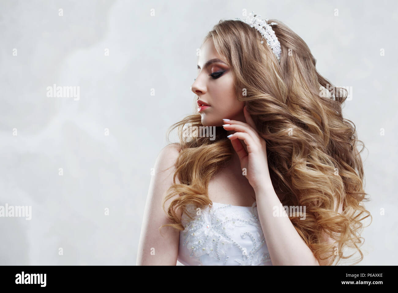 Young Charming Bride In Wedding Dress Make Up And Hairstyle With