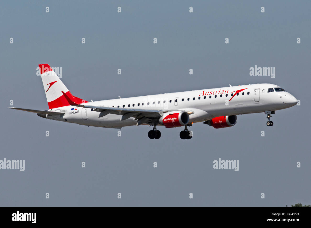 An Austrian Airlines Embraer EMB-195 airliner, OE-LWE, prepares to land at Manchester Airport in England. Stock Photo
