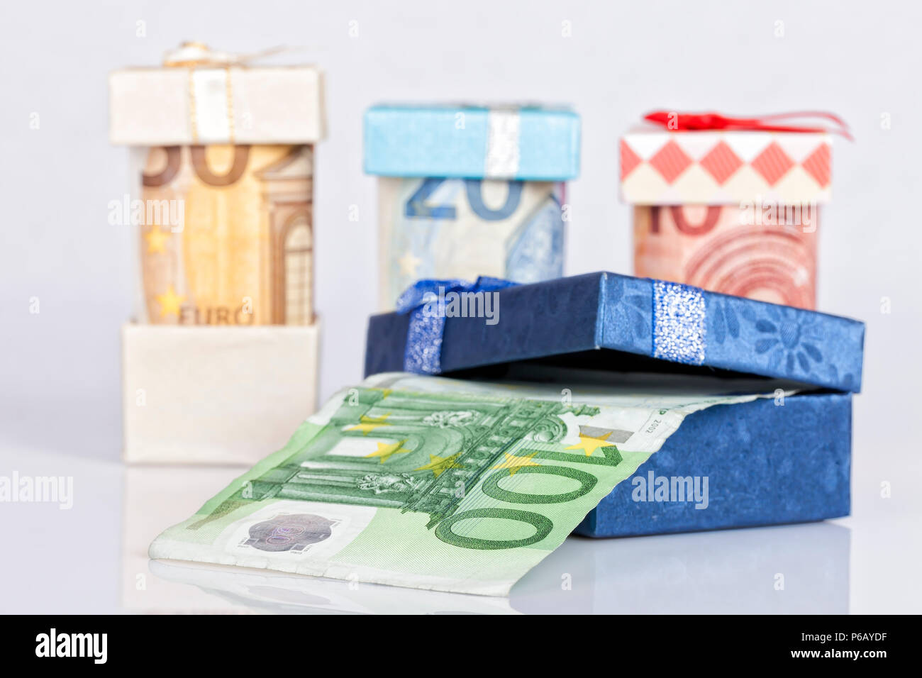 Several euro bills inside gift boxes isolated on white background. Stock Photo