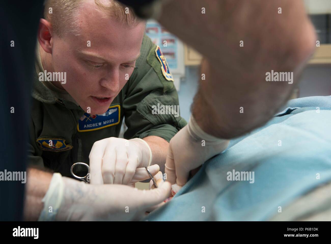 U.S. Air Force Capt. Andrew Moss, 39th Medical Operations Squadron flight surgeon, performs a cyst removal May 19, 2016, at Incirlik Air Base, Turkey. Flight surgeons are primary care physicians for aircrew members. (U.S. Air Force photo by Senior Airman John Nieves Camacho/Released) Stock Photo