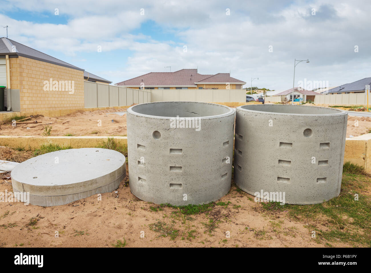 Two concrete soakwells with covers on the construction site before installation Stock Photo