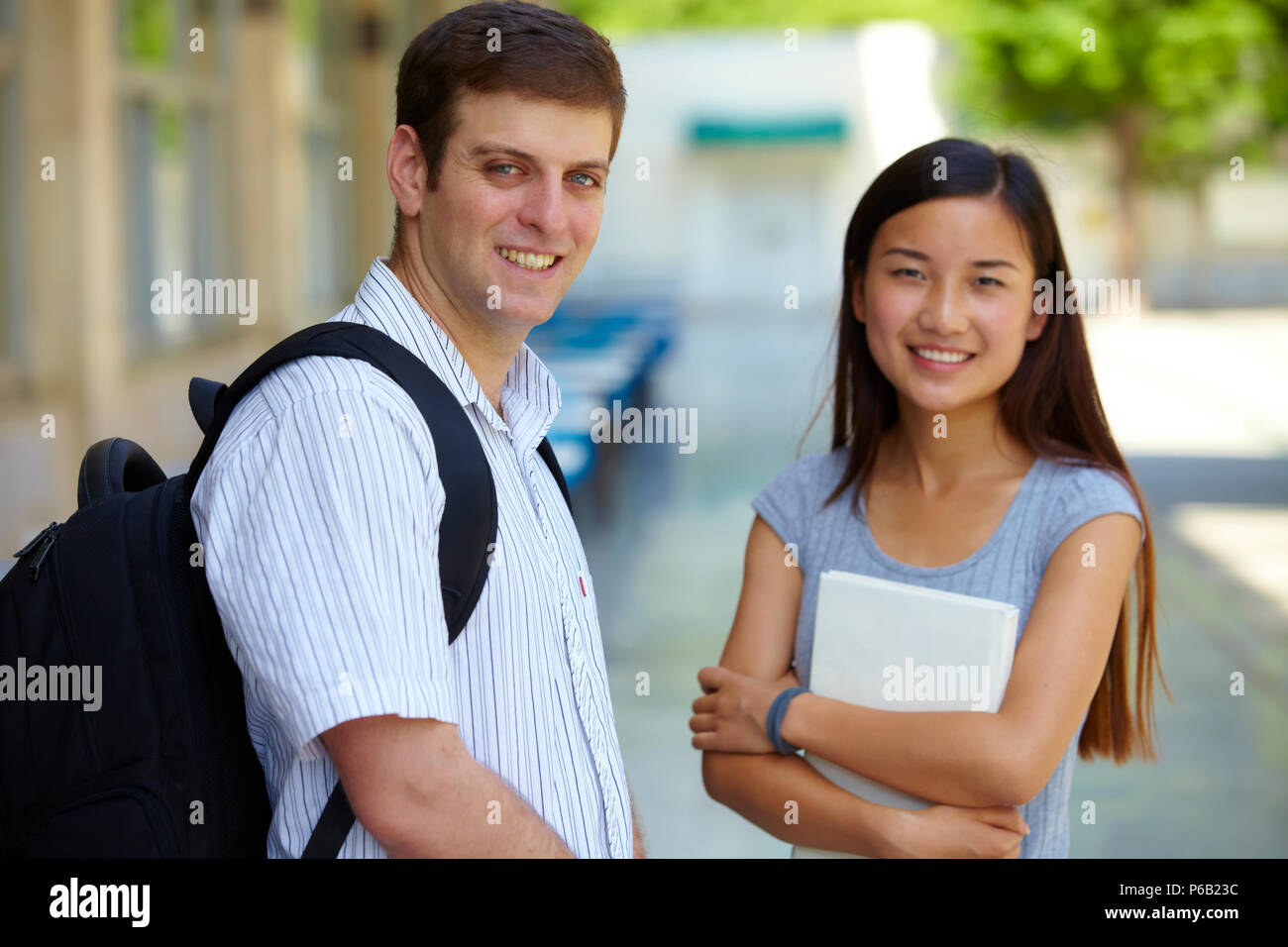 Caucasian male college students study together with asian female ...