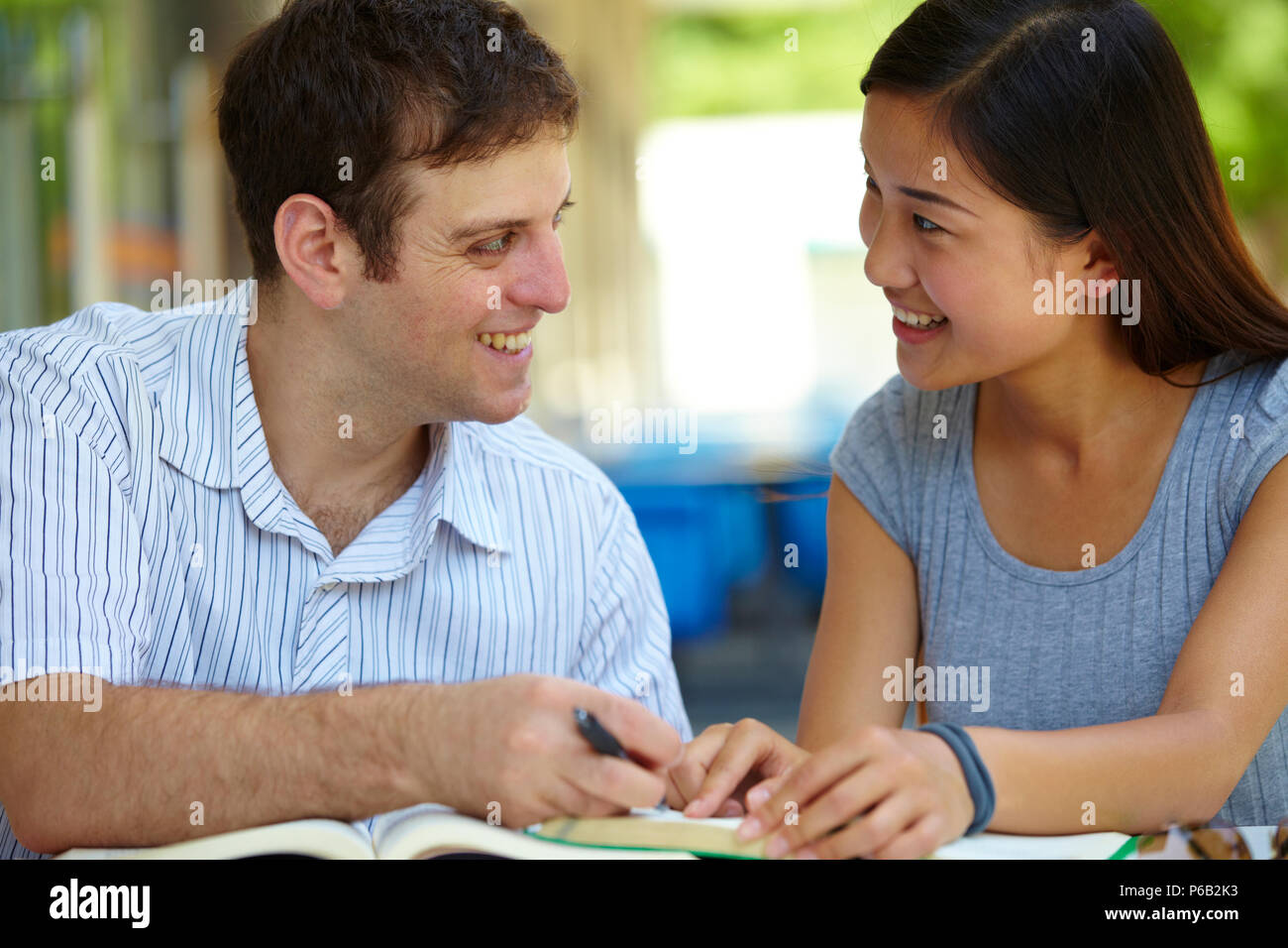 asian college students study together with European student in campus Stock Photo