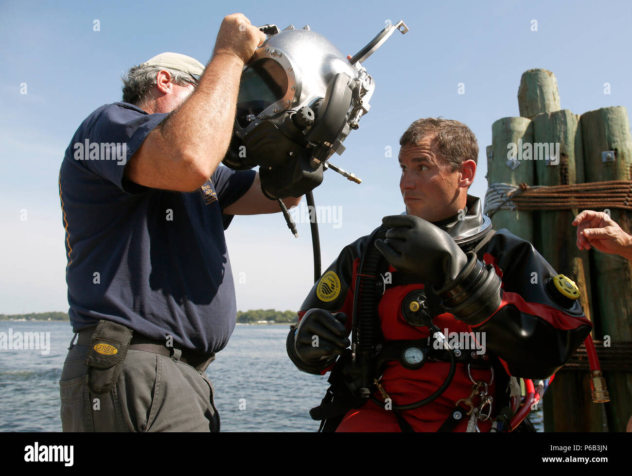 Rocky Heikkinen of Dive Lab raises a Kirby diving helmet over