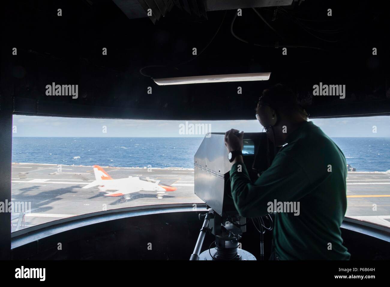 170210-N-KJ380-050 ATLANTIC OCEAN (Feb. 10, 2017) Electrician's Mate 3rd Class Aaron Ayersman records a T-45C Goshawk training aircraft assigned to Carrier Training Wing (CTW) 2 with the integrated launch and recovery television system as it makes an arrested landing on the flight deck of the aircraft carrier USS Dwight D. Eisenhower (CVN 69). The ship is conducting aircraft carrier qualifications during the sustainment phase of the Optimized Fleet Response Plan. (U.S. Navy photo by Mass Communication Specialist Seaman Neo Greene III/Released) Stock Photo
