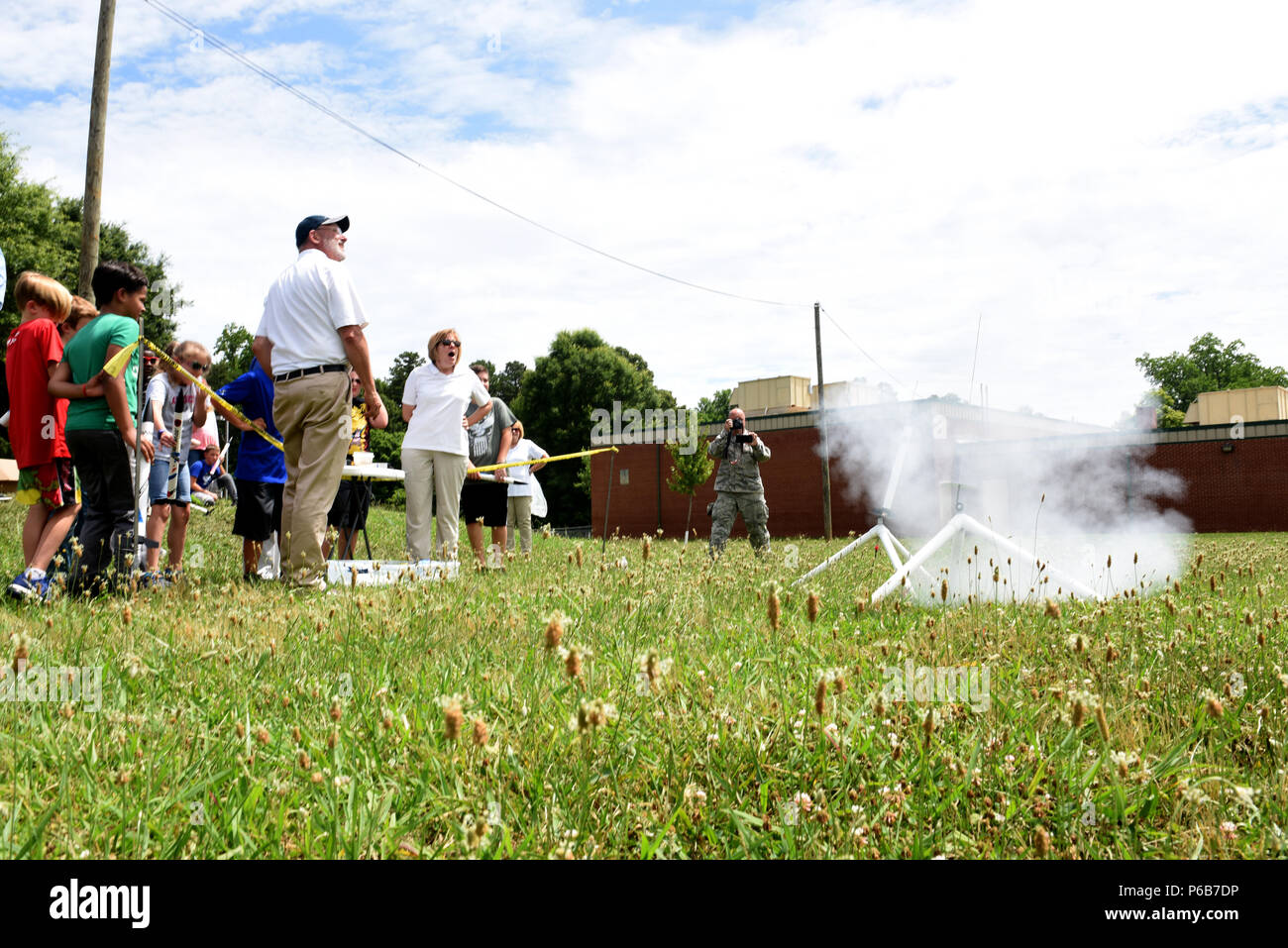 Parents, campers, and teachers watch as model rockets launch near Reid Park Academy Charlotte, N.C., June 21, 2018. The campers and teachers are part of the annual Department of Defense STARBASE summer camp program with the North Carolina Air National Guard and they learn various applications of science, technology, engineering, and math. Stock Photo