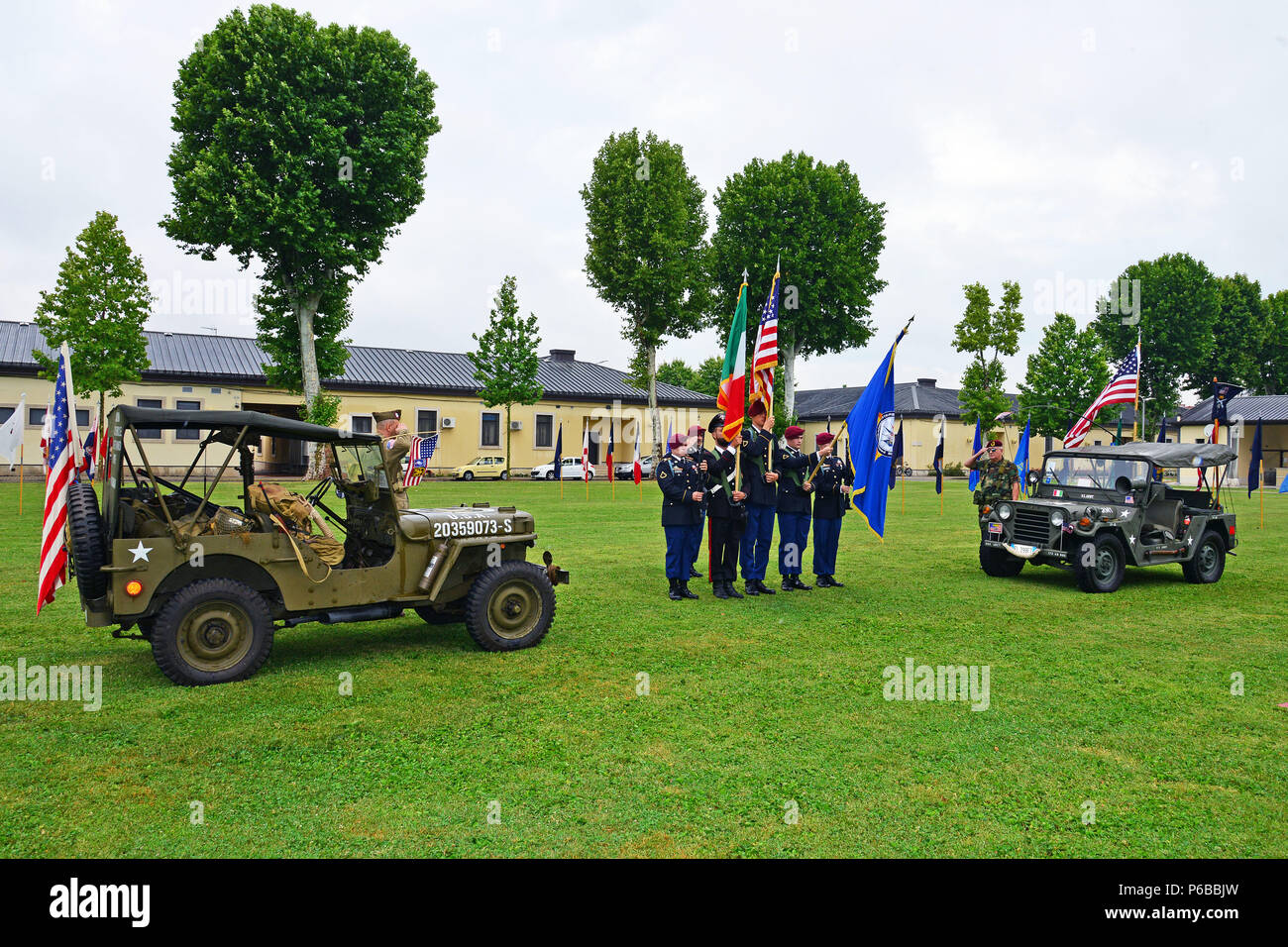 U. S. Army Soldiers, Italian Carabinieri and historical characters with military vehicles dating back to World War II, salute during the playing of the U.S. and Italian national anthems during a retirement ceremony at Caserma C. Ederle Vicenza, Italy, June 22, 2018. (U.S. Army photo by Paolo Bovo). Stock Photo
