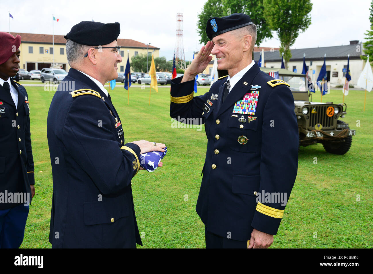 General Curtis M. Scaparrotti, Supreme Allied Commander Europe (SACEUR) commander (left), presents the American flag to Maj. Gen. Gordon B. “Skip” Davis Jr., Combined Security Transition Command – Afghanistan, Commander, during a retirement ceremony at Caserma C. Ederle Vicenza, Italy, June 22, 2018. (U.S. Army photo by Paolo Bovo). Stock Photo