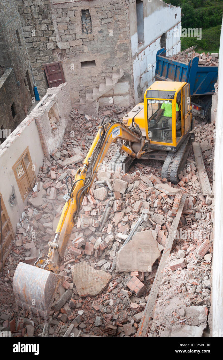 Excavator shovel tearing a wall down, demolition of a building, Barcelona Stock Photo