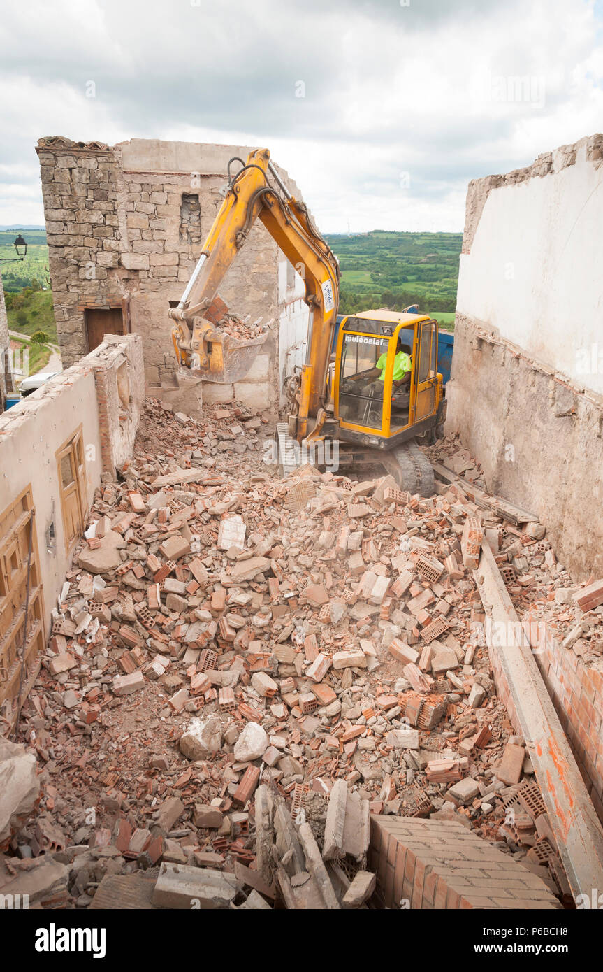 Excavator shovel tearing a wall down, demolition of a building, Barcelona Stock Photo