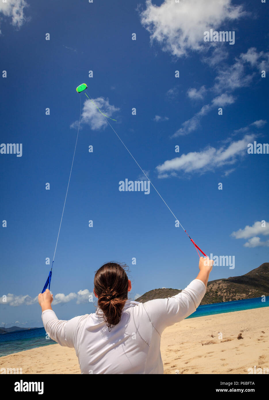 Woman flying kite on the beach hi-res stock photography and images - Alamy