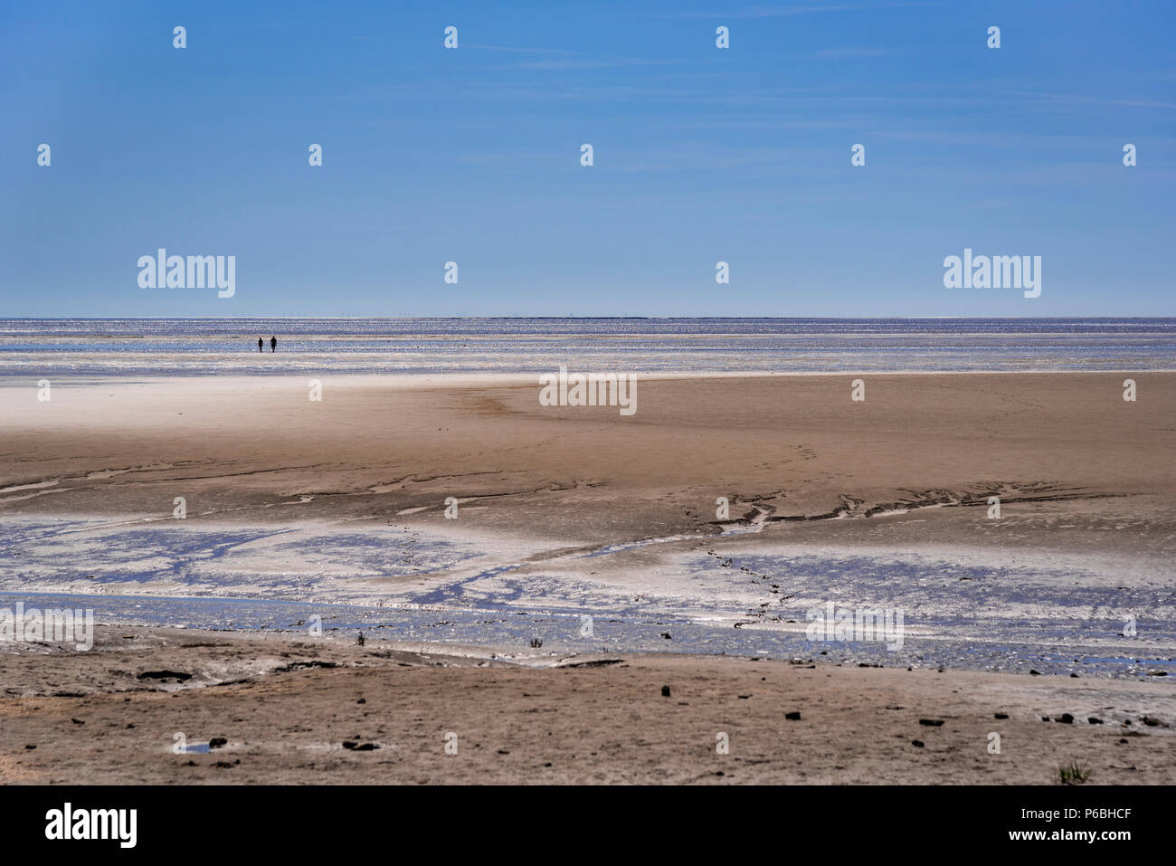 Walkers on Morecambe Bay sands. Lancashire North West England Stock