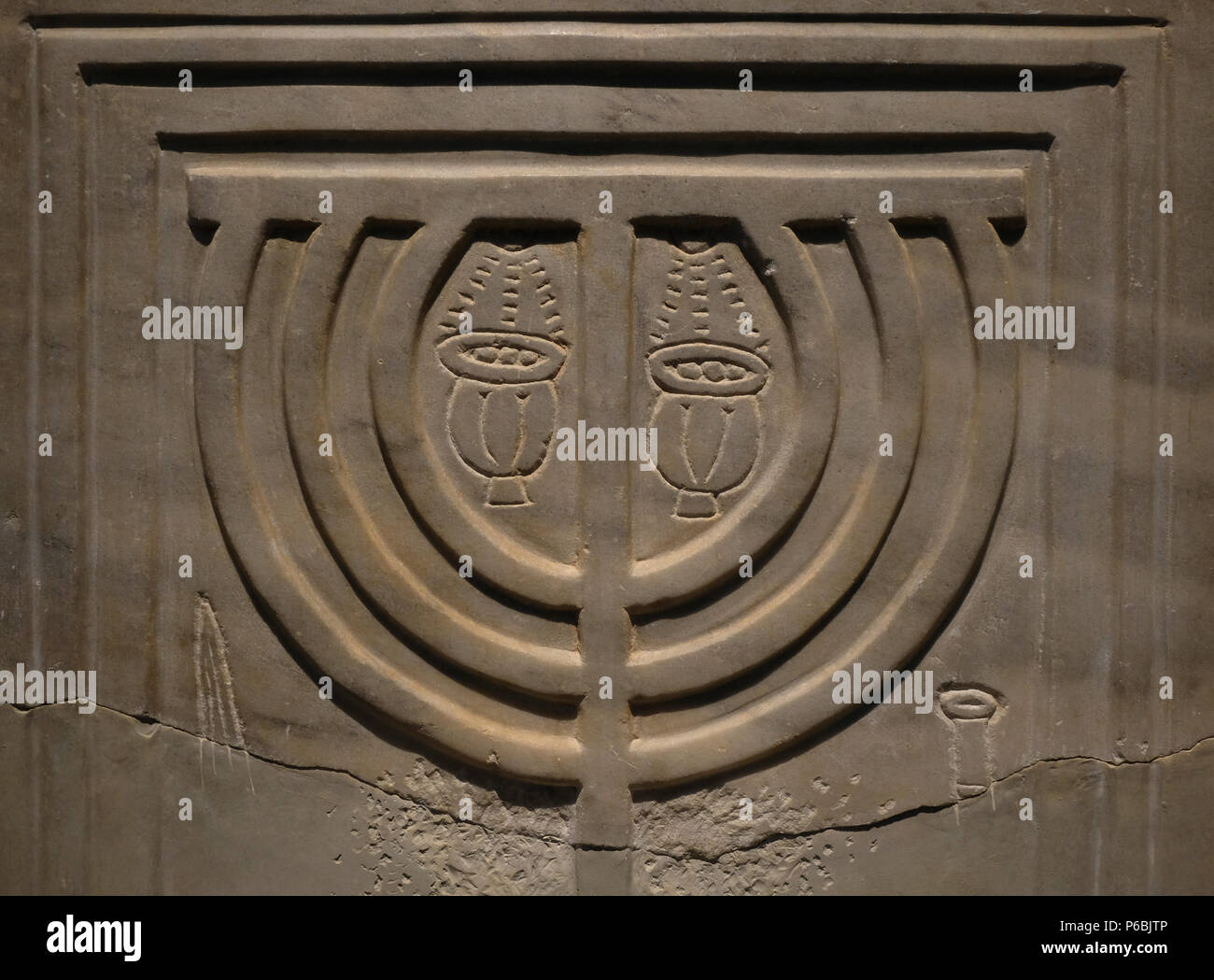 The Jewish Menorah carved in remain of the ancient synagogue (4-9th centuries CE) of Susya or Susiya archaeological site located in the southern Judea displayed at the Archeology Wing of the Israel Museum in West Jerusalem Israel Stock Photo