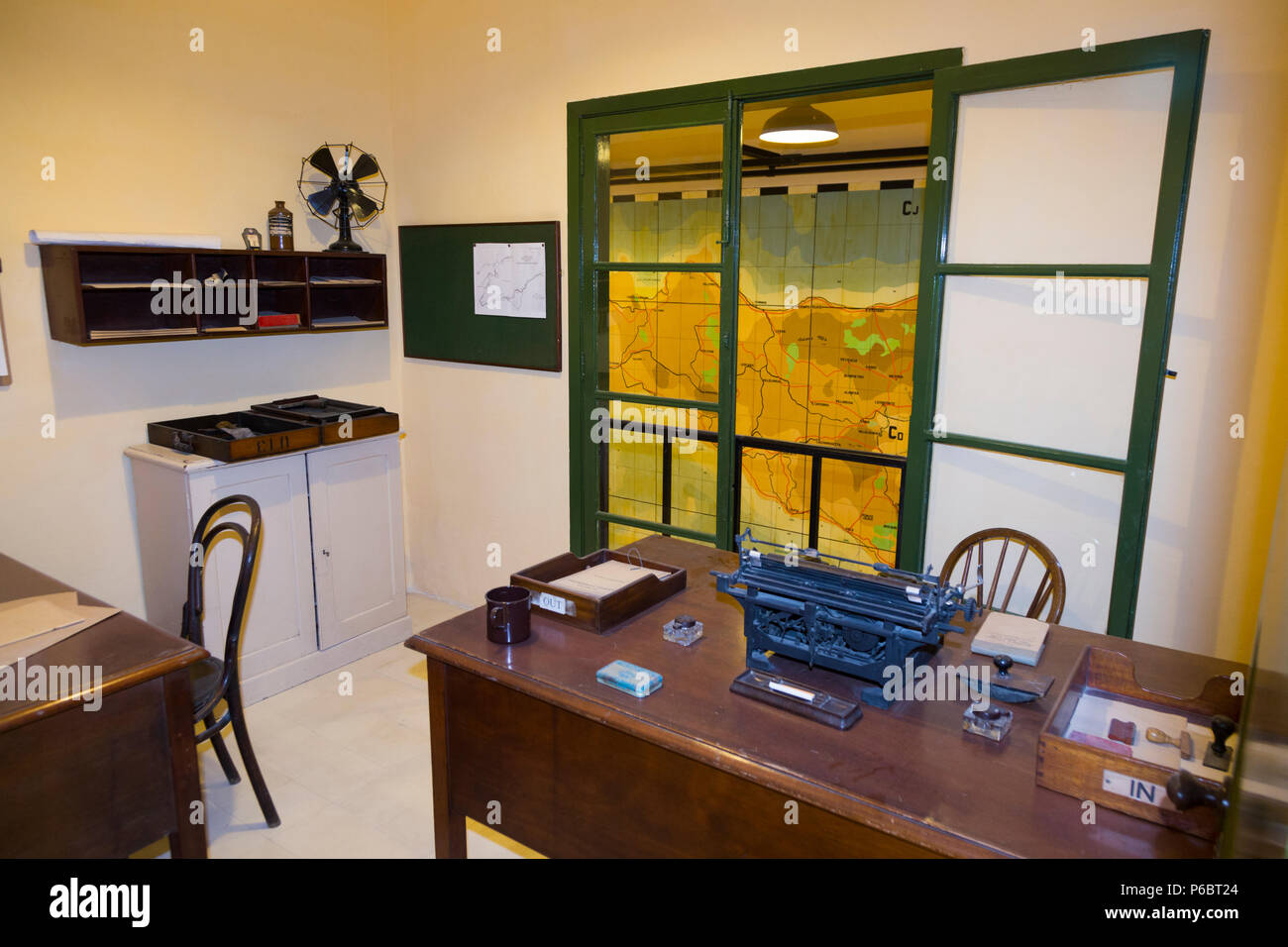Office with vintage desk, chair and typewriter, and window overlooking map of the island of