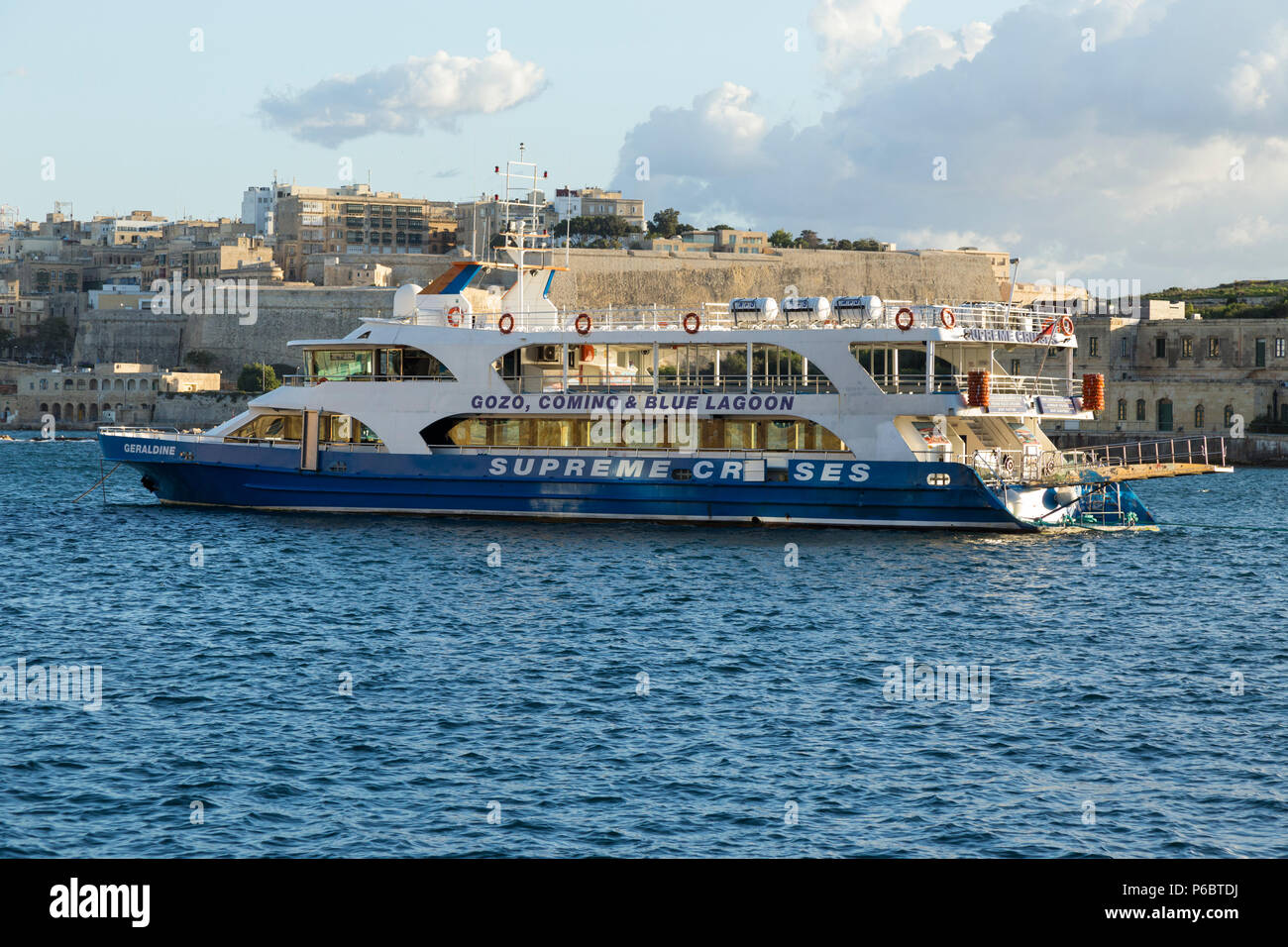 A tourist sightseeing boat ' The Geraldine ' operated by Supreme Cruises to visit Gozo, Comino, and Blue lagoon, moored in the Grand Harbour, Valletta, the island of Malta. (91) Stock Photo
