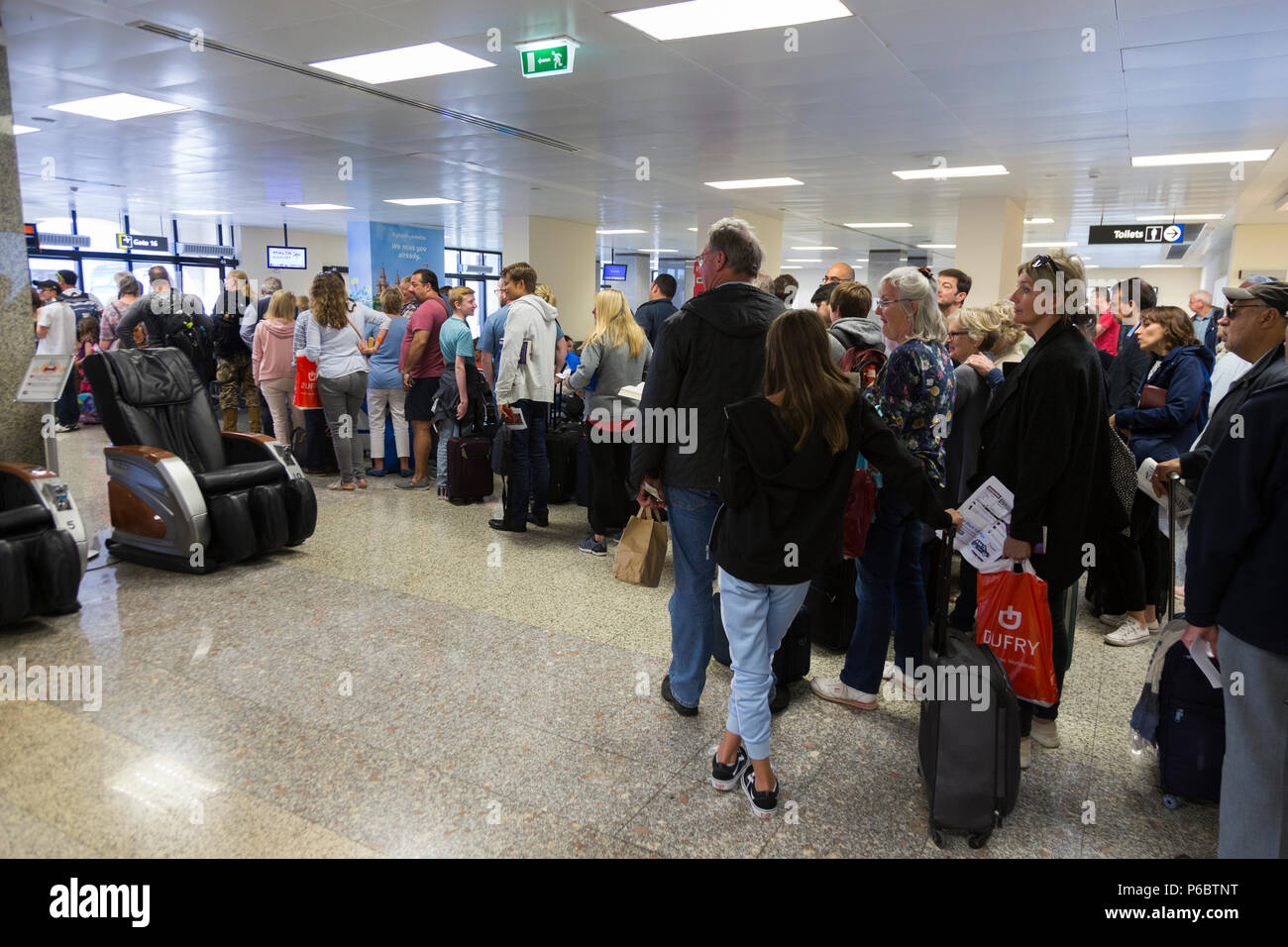 Easyjet passengers in queue / queuing / queues / waiting to board a plane at departure gate 15 at Malta International Airport. (91) Stock Photo