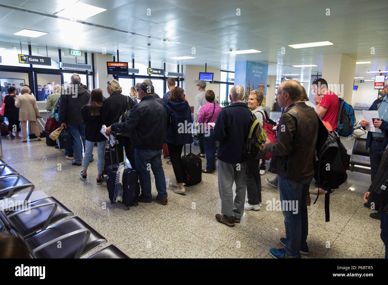 Easyjet passengers in queue / queuing / queues / waiting to board a plane at departure gate 15 at Malta International Airport. (91) Stock Photo