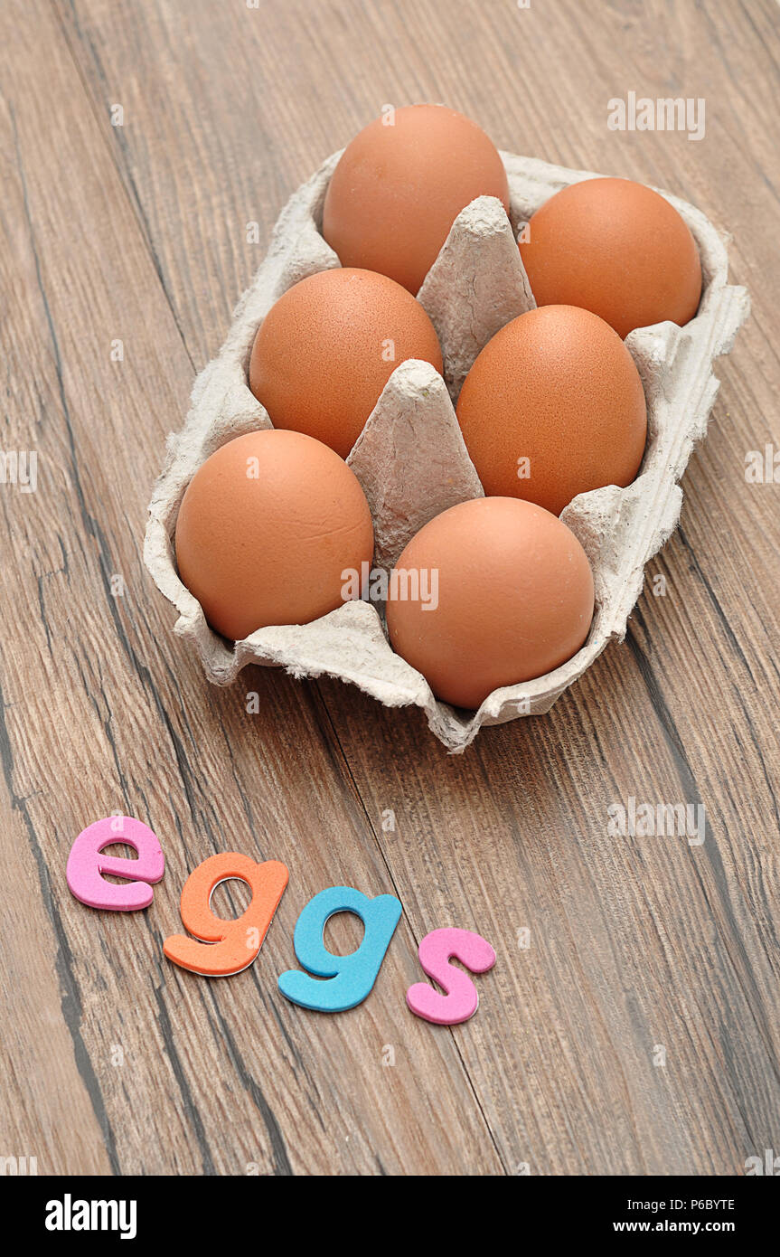 The word eggs displayed with chicken eggs in a egg box Stock Photo Alamy