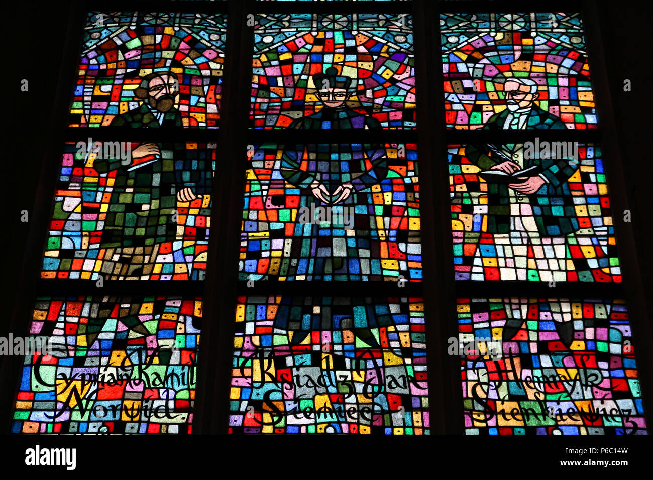 Warsaw archcathedral interior detail - stained glass depicting famous Polish people. Cyprian Kamil Norwid, Jan Siemiec and Henryk Sienkiewicz. Stock Photo