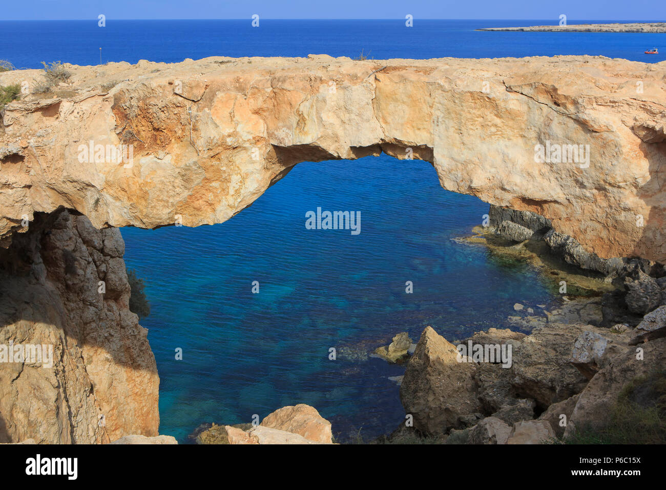 Natural Bridge (Kamara Tou Koraka) with a view across the turquoise water of the Mediterranean Sea near Cape Greco, Cyprus Stock Photo
