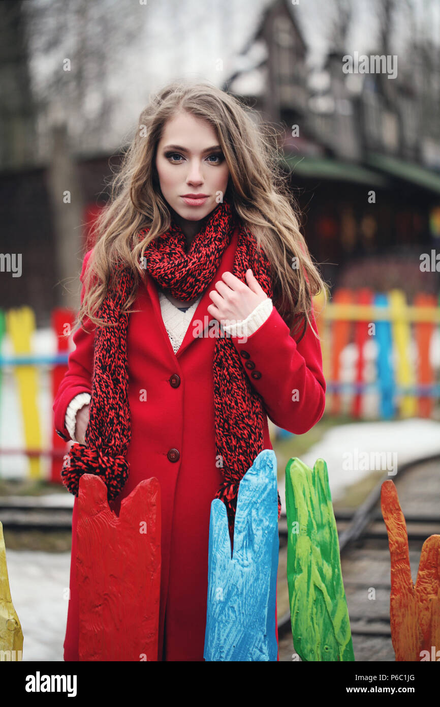 Fashionable woman in red winter coat and scarf outdoors Stock Photo - Alamy
