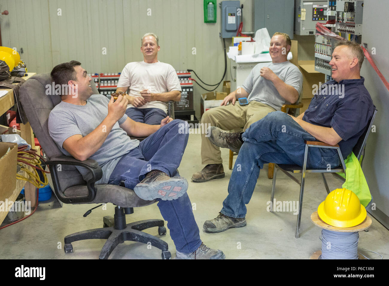Engineers sitting to an electric power plant Stock Photo
