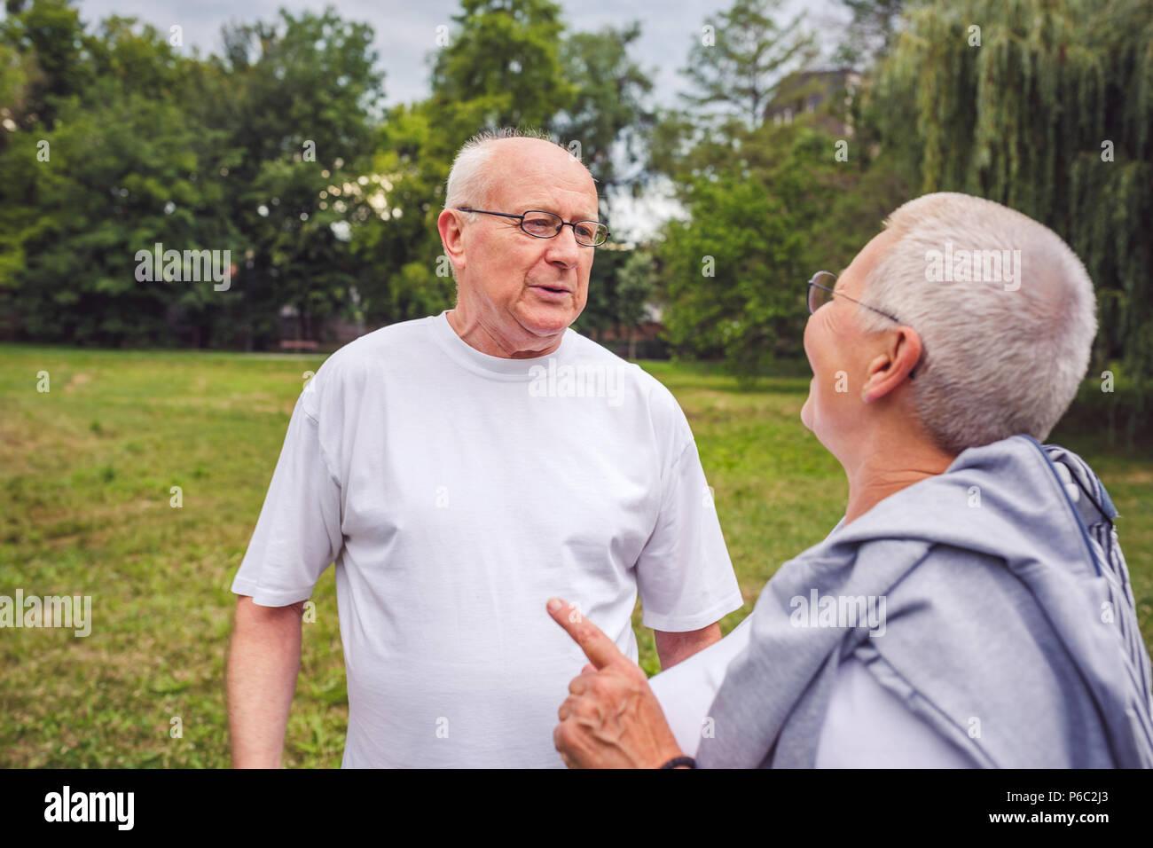 Smiling senior couple enjoying a moment and talking together Stock Photo