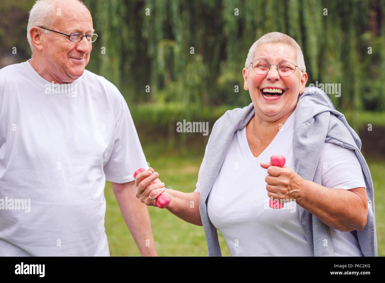 Happy senior couple exercise in park together Stock Photo