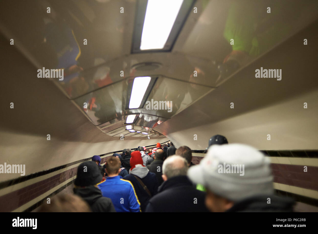 Crowds walking down the tunnel towards the London Underground station