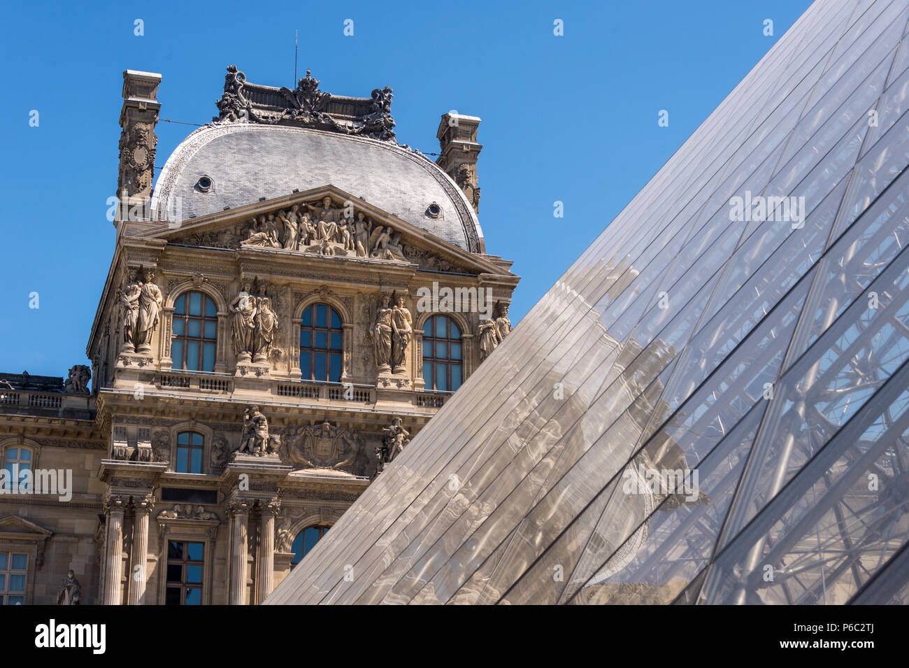 Paris, France - 23 June 2018: Louvre museum and Louvre Pyramid in summertime Stock Photo