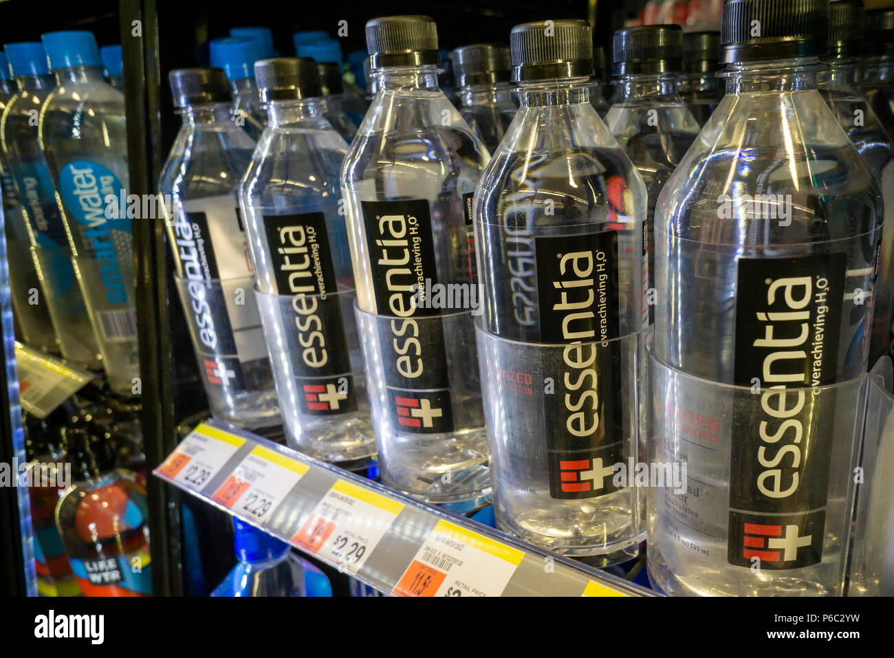 Bottles of Essentia and other waters in a cooler in a convenience store in New York on Thursday, June 14, 2018. Essentia, one of players in the functional water space, has hired Credit Suisse to run an auction of the company hoping to attract a larger beverage brand such as PepsiCo or Nestle. Essentia claims superior hydration due to a proprietary method of ionizing the water. (© Richard B. Levine) Stock Photo