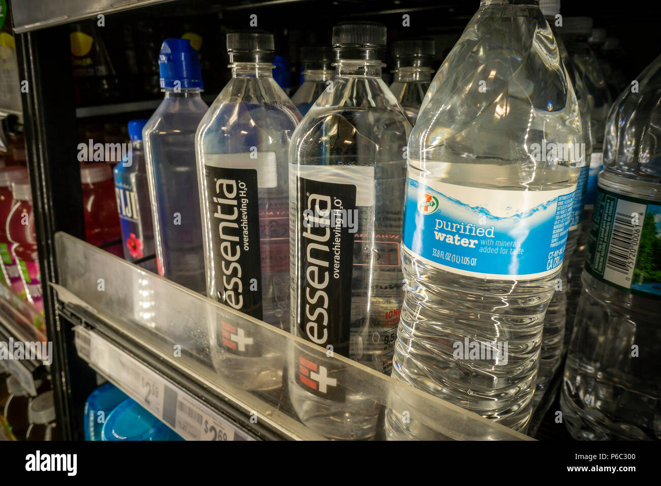 Bottles of Essentia and other waters in a cooler in a convenience store in New York on Thursday, June 14, 2018. Essentia, one of players in the functional water space, has hired Credit Suisse to run an auction of the company hoping to attract a larger beverage brand such as PepsiCo or Nestle. Essentia claims superior hydration due to a proprietary method of ionizing the water. (Â© Richard B. Levine) Stock Photo