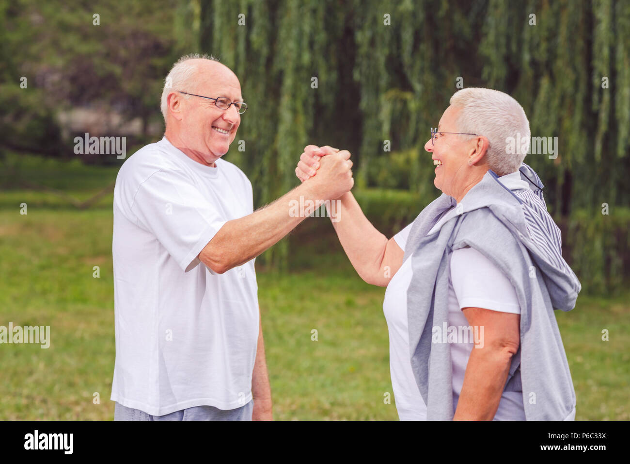 healthy aged smiling couple resting after sport exercises- together we workout better Stock Photo