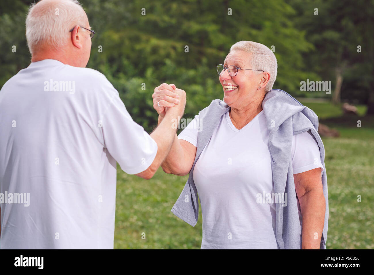 together we workout better- Smiling senior couple exercise and having fun together Stock Photo