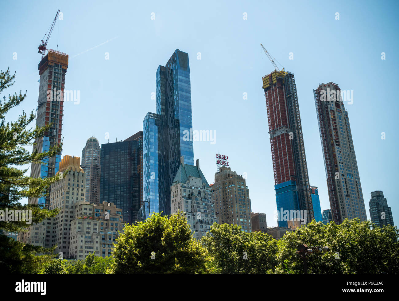 Skyscrapers constructed and under construction along the West 57th Street corridor in Midtown Manhattan in New York destined a shadows over Central Park, seen on Saturday, June 16, 2018. A recent study reported that the One57 and other proposed and under construction 'mega-towers' for the 'Ã¼ber-rich' over 1000 feet will cast long shadows at certain times of the year plunging parts of the southern section of the landmark Central Park in shadow. The buildings achieve their height by purchasing the air rights of smaller buildings. (Â© Richard B. Levine) Stock Photo