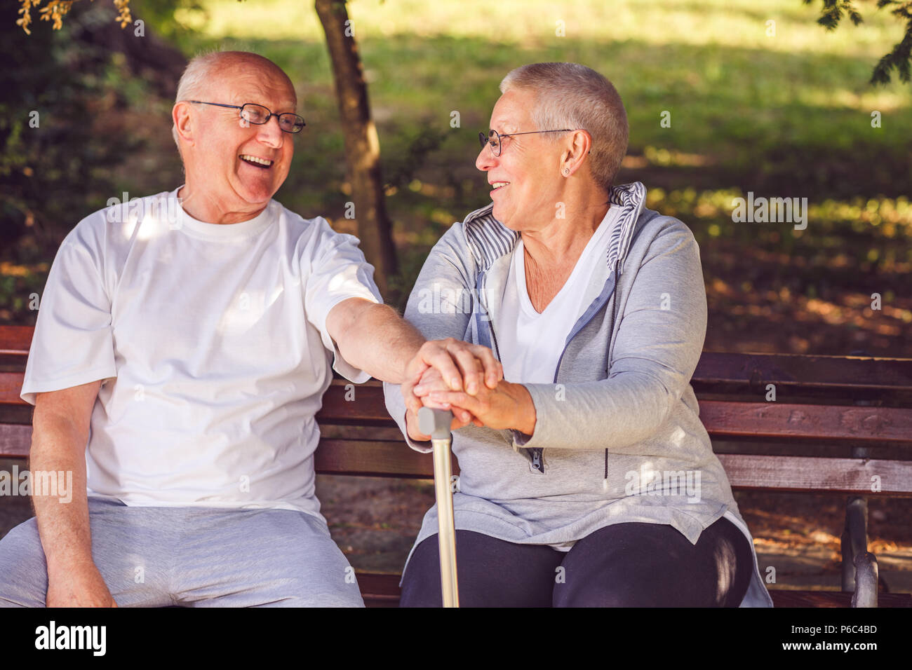 Happy together. Delighted positive elderly couple looking at each other and smiling while feeling happy together Stock Photo