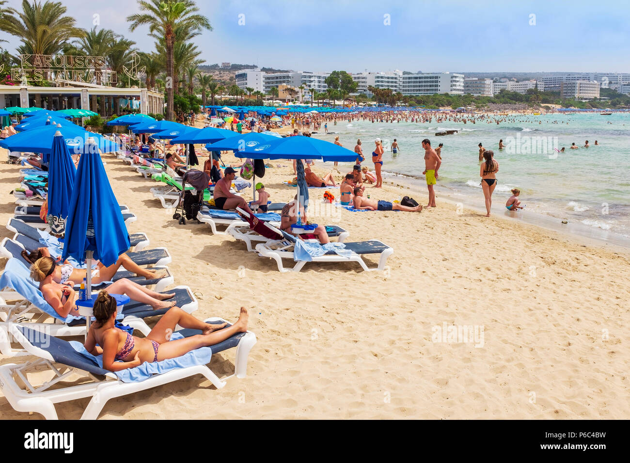 Tourists on the beach at Karousas Beach, Ayia Napa, Cyprus Stock Photo