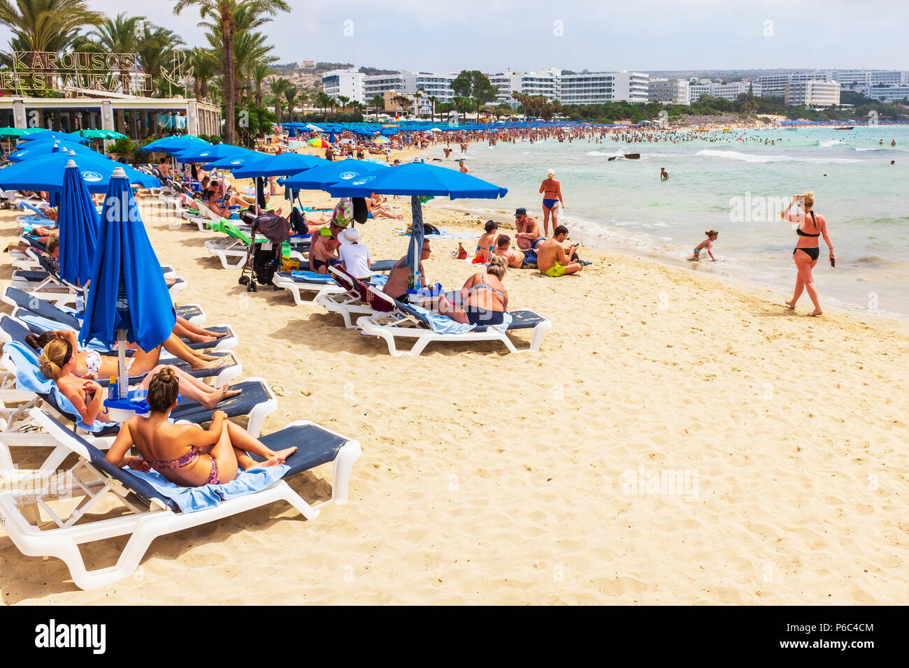 Tourists on Karousos Beach, Ayia NApa, Cyprus Stock Photo