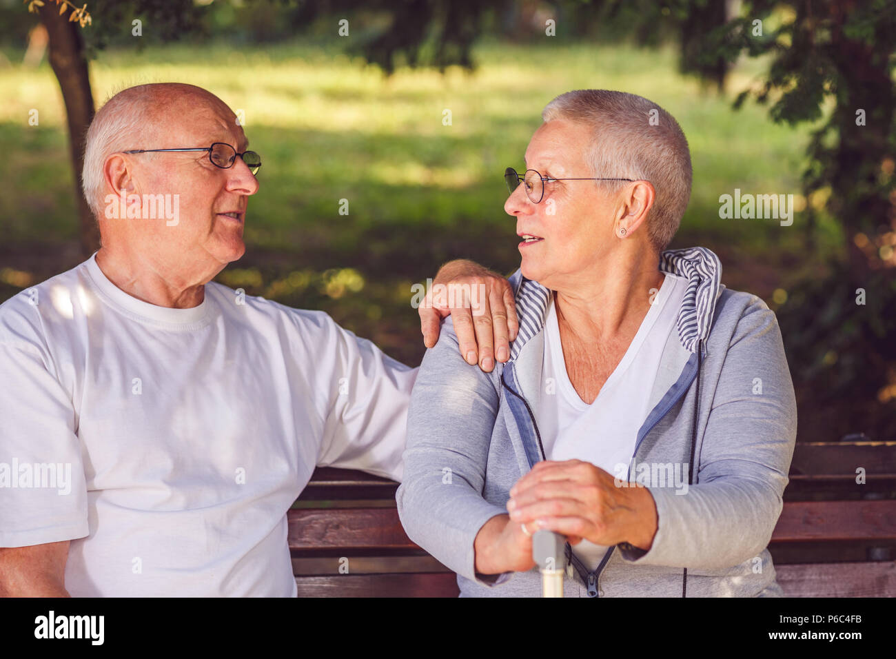 Happy elderly couple relaxing outdoors on a summer day Stock Photo