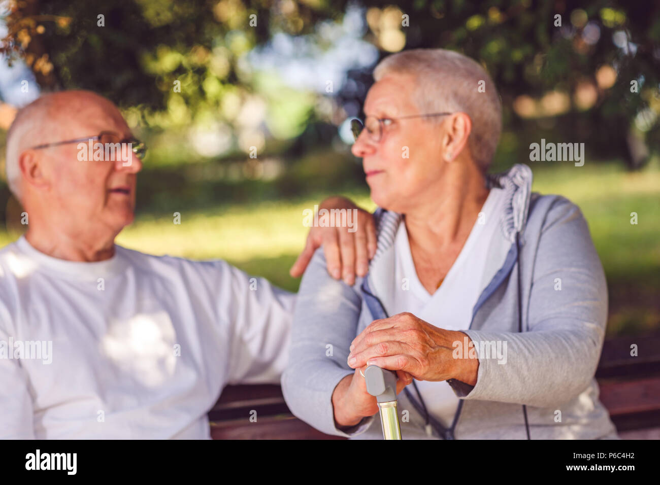 hands of senior woman during walk in park on sunny day Stock Photo