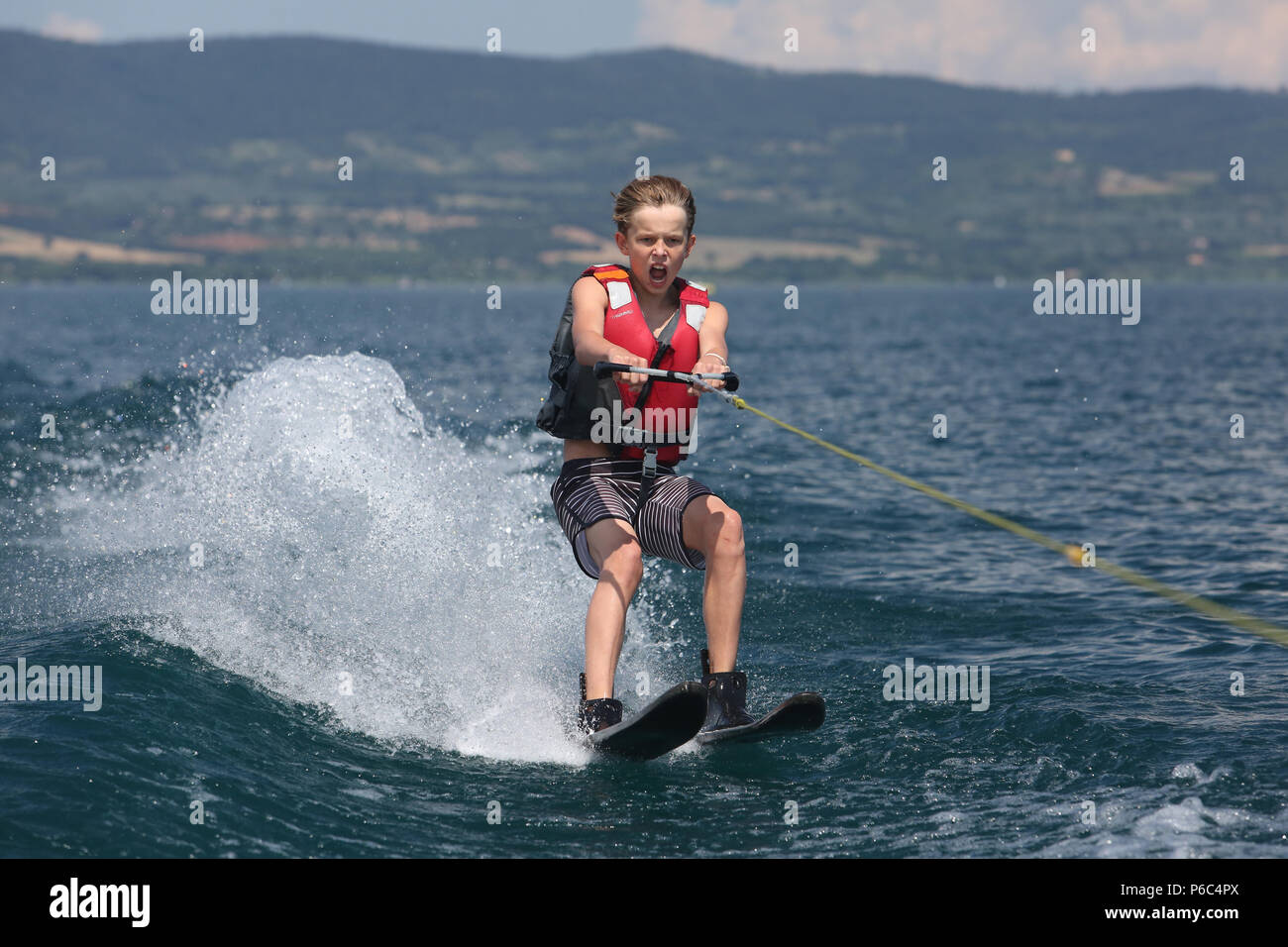 Capodimonte, Italy, boy is water skiing on Lake Bolsena Stock Photo