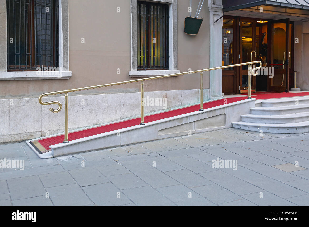Wheelchair Ramp With Red Carpet for Easy Access in Building Stock Photo