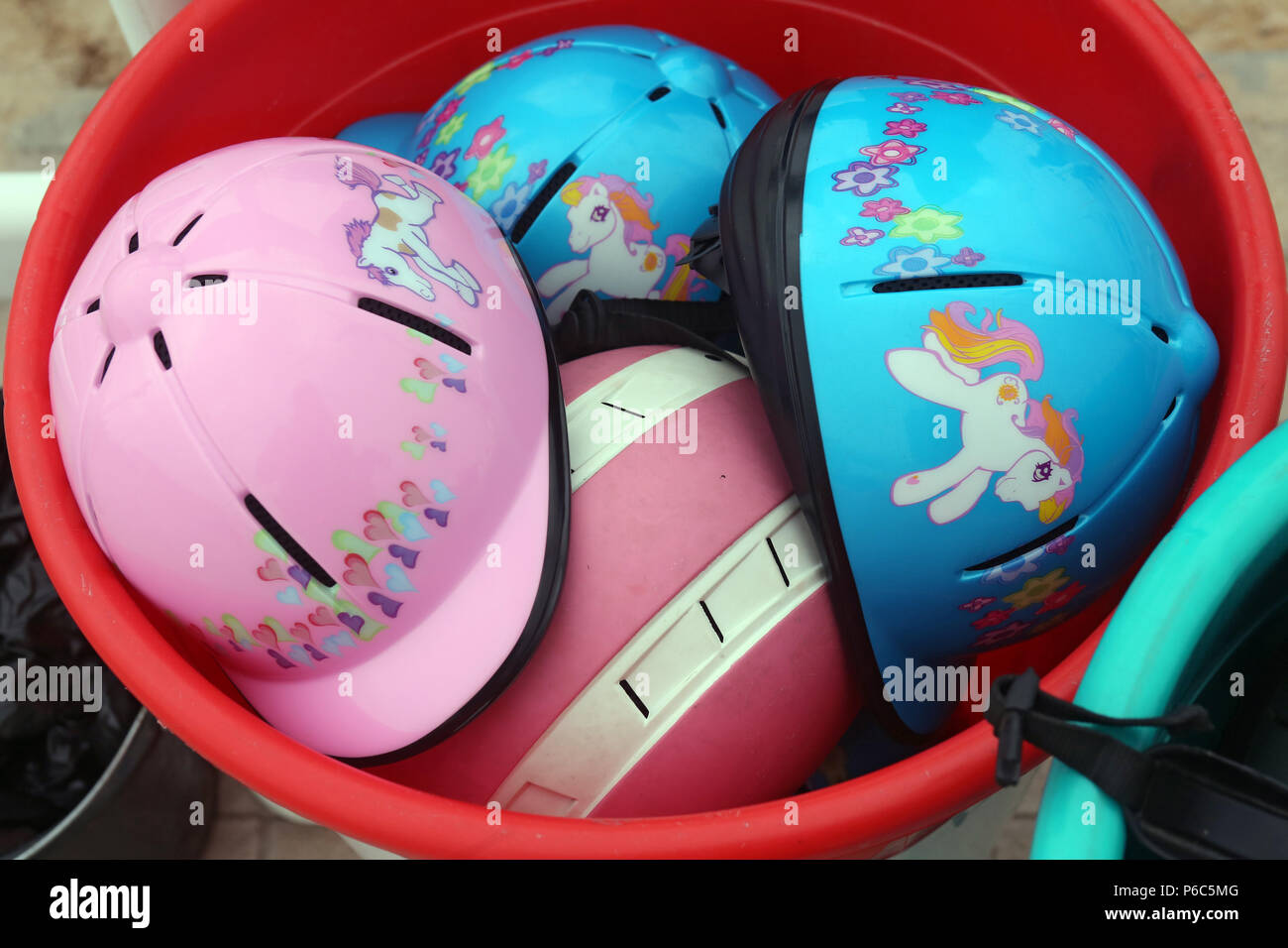 Doha, riding helmets for children in a bucket Stock Photo