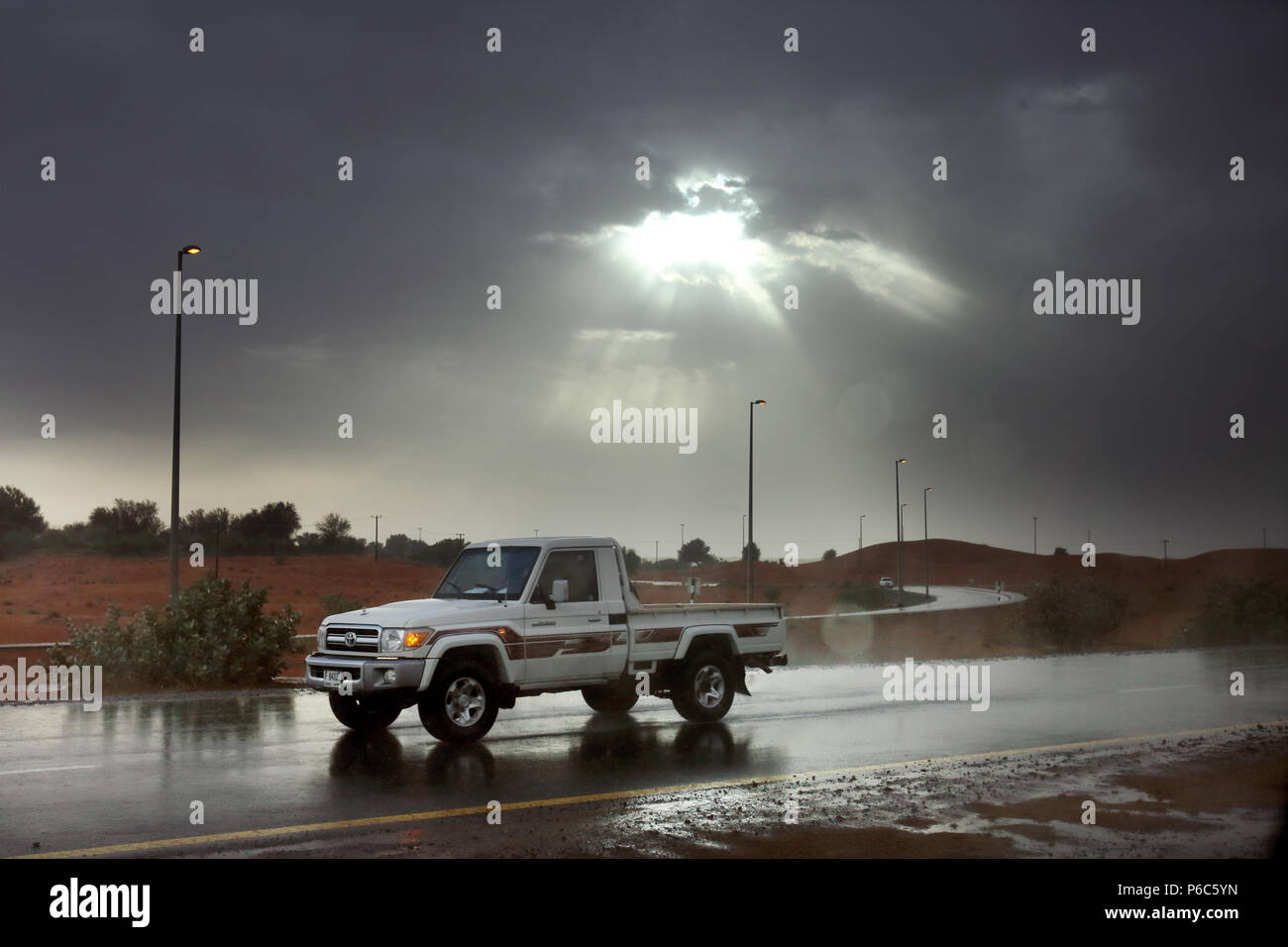Dubai, United Arab Emirates, Jeep rides through the desert in the rain Stock Photo