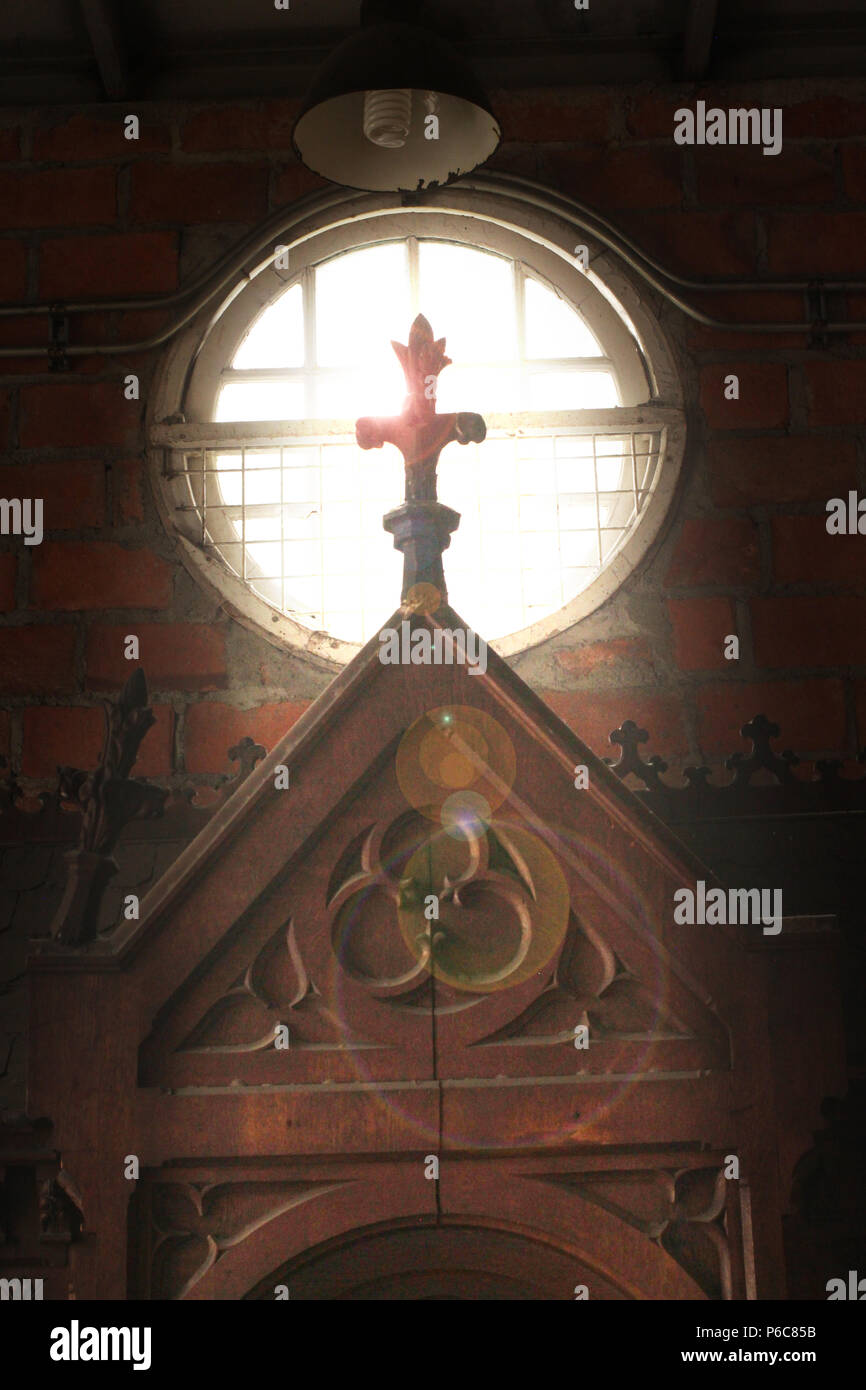cross against the light from round window made some lens flare Stock Photo Alamy